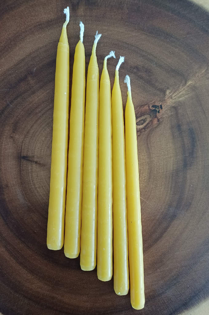 Hand dipped beeswax candles. Dimensions of candle 14 cm tall by 1 cm diameter. Burn time Up to 1 ½ hours