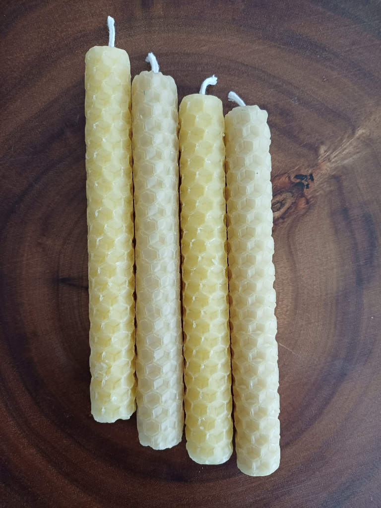 Hand rolled beeswax sheet candles. Dimensions of candle 13cm long by 1.5cm diameter. 1 to 2 hours burn time. Set of 4